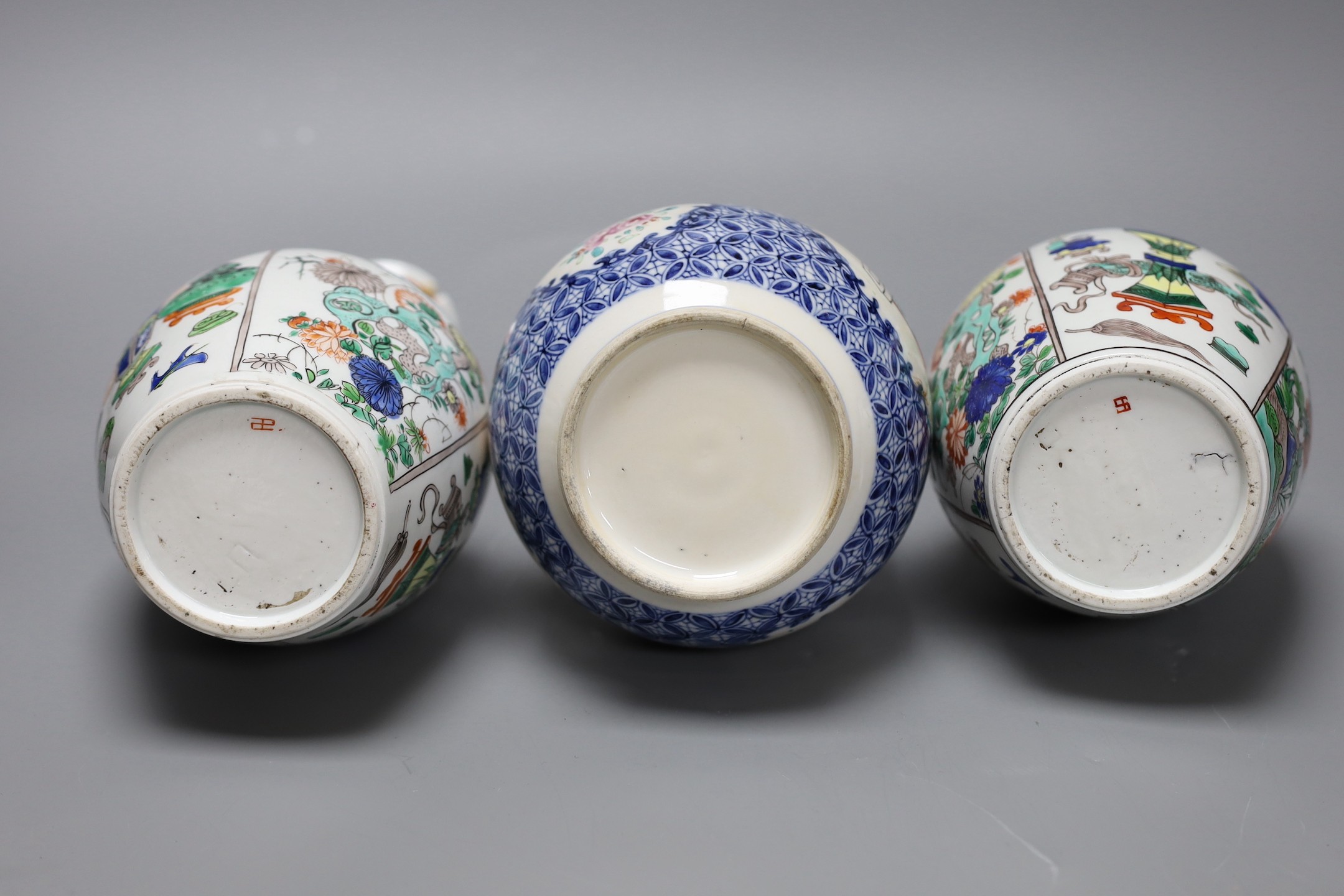 A pair Samson of Paris vases in the Chinese famille verte style and a Chinese Qianlong famille rose garlic neck vase with blue panelling motif, tallest 26cm